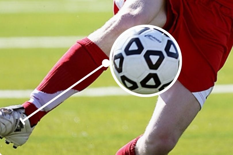 Player in red jersey using first touch, one of the basic fundamental football skill 